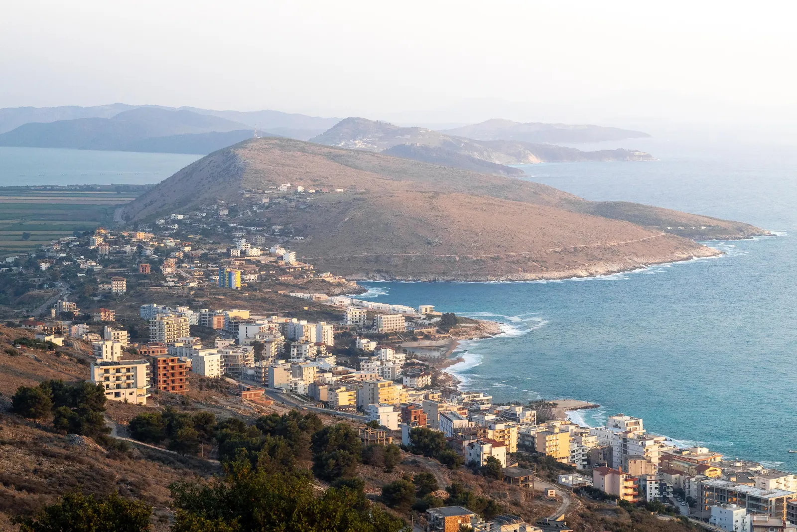 Sarandë and its bay seen from the hill below Lëkurësi Castle, with the coast towards Ksamil beyond